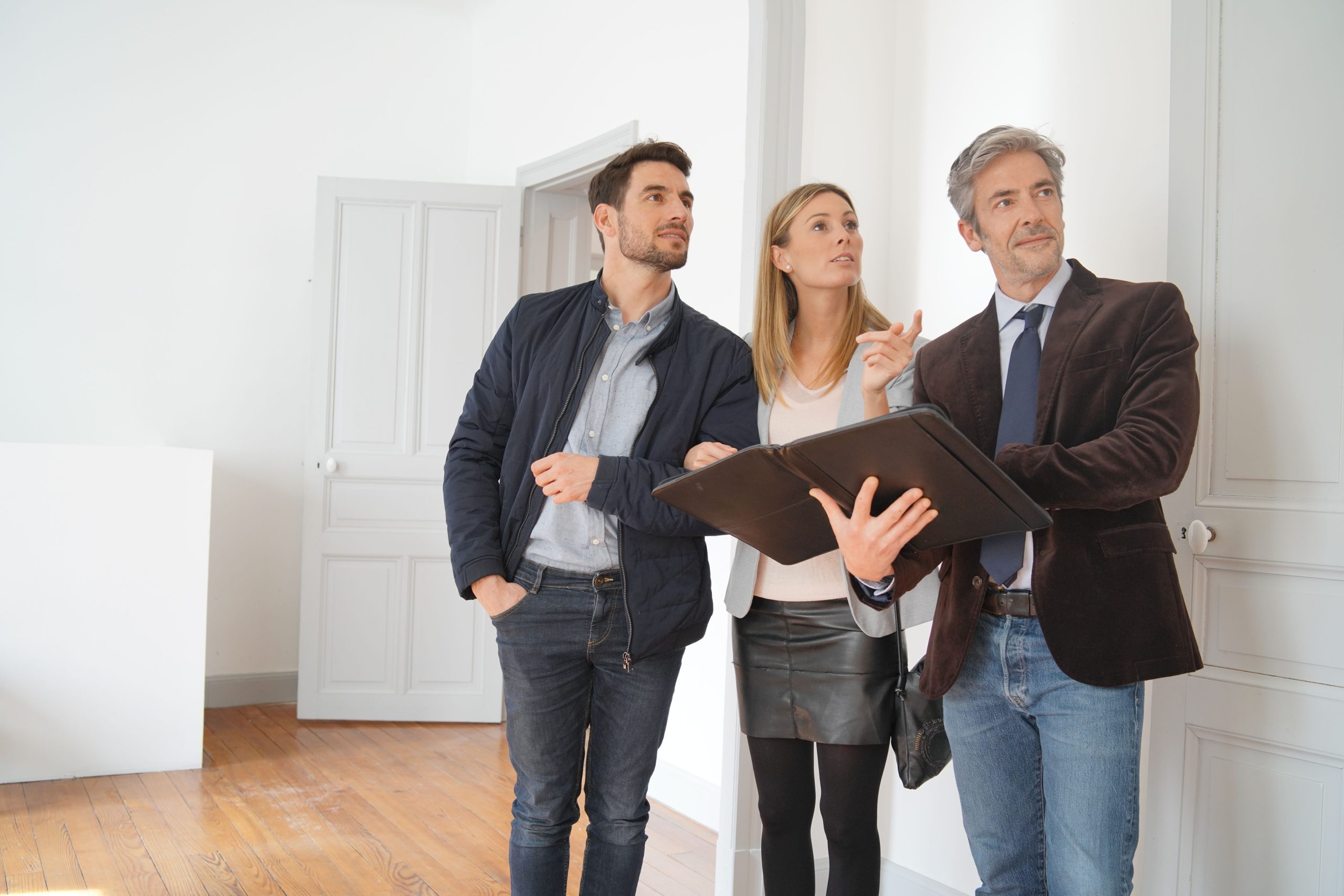 Couple with real-estate agent visiting light contemporary house